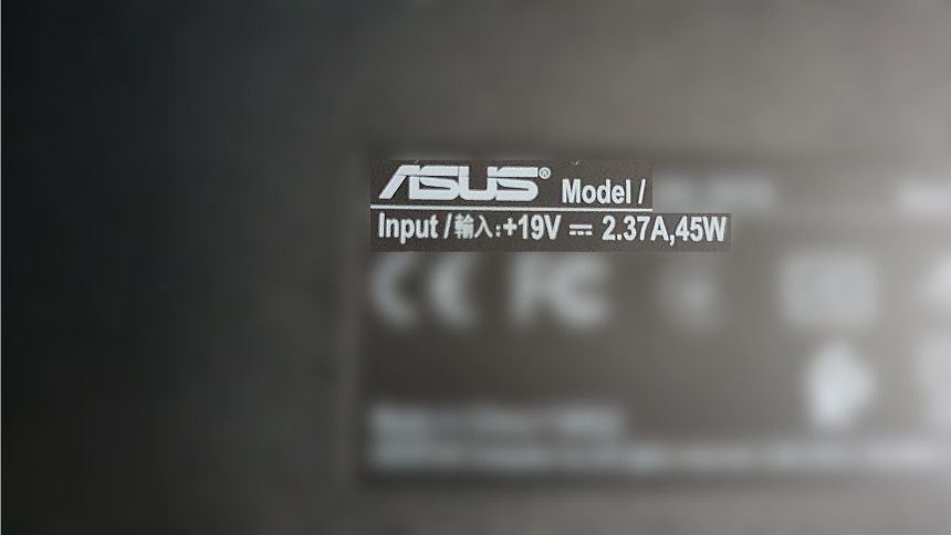 ASUS Laptop Voltage Requirements image of the power spec label on the underside of the laptop